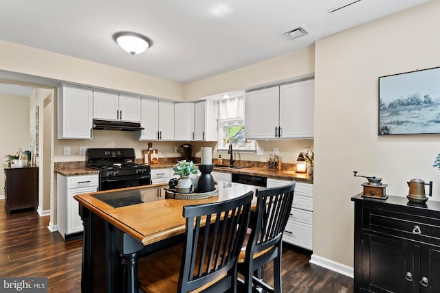 6111 Summit Pointe Dr, Harrisburg, PA 17111 - kitchen with black gas range, under cabinet range hood, white cabinetry, and dark wood-style flooring