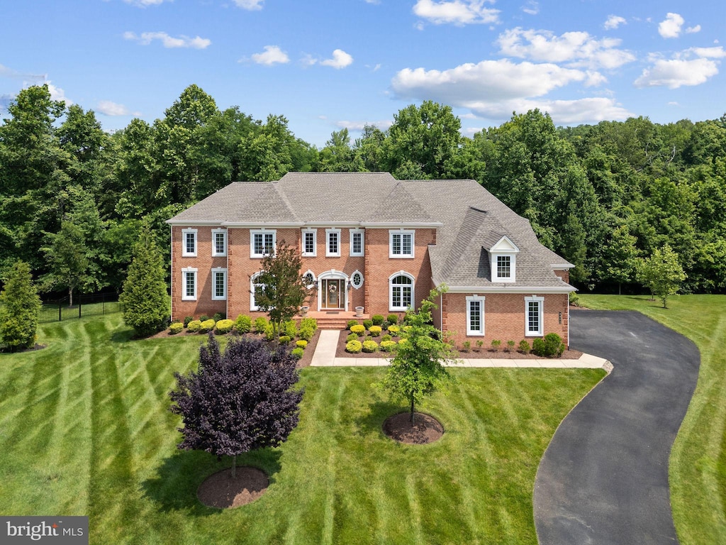 4400 Palomino Xing, Upper Marlboro, MD 20772 - colonial-style house featuring brick siding, a front yard, and asphalt driveway