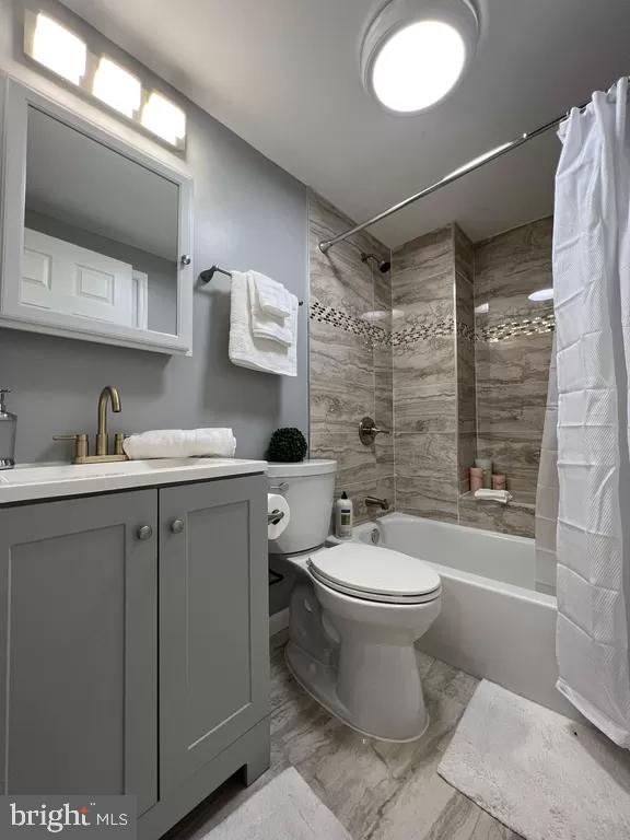 2057 N Franklin St, Philadelphia, PA 19122 - full bath featuring shower / tub combo with curtain, vanity, and marble look tile flooring