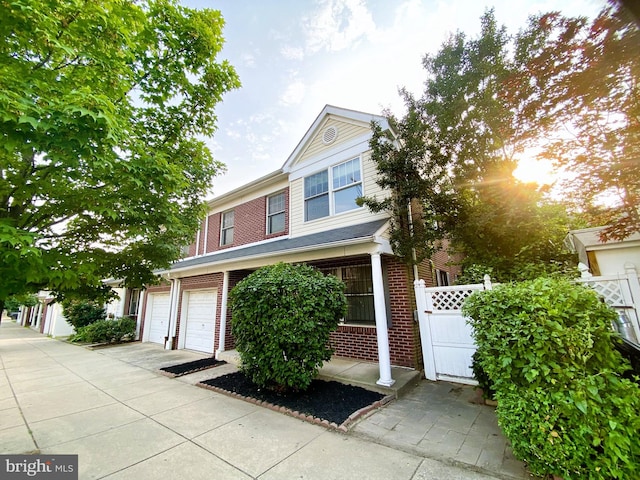 1328 S 5th St, Philadelphia, PA 19147 - view of front facade featuring brick siding, a garage, and a gate