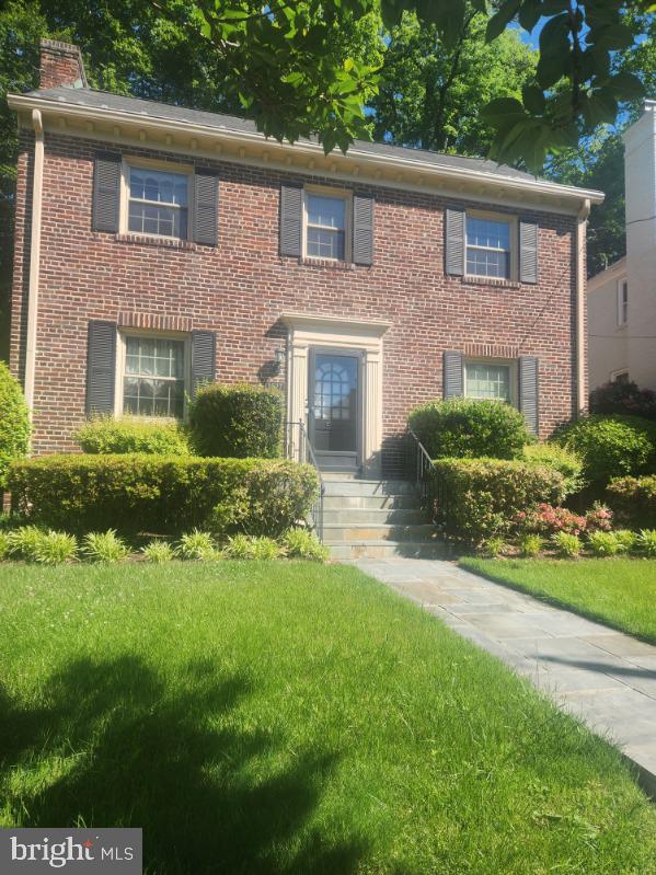1627 Myrtle St NW, Washington, DC 20012 - colonial-style house with a front lawn, brick siding, and a chimney