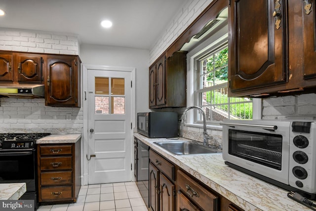 1627 Myrtle St NW, Washington, DC 20012 - kitchen featuring black appliances, range hood, light countertops, light tile patterned floors, and recessed lighting