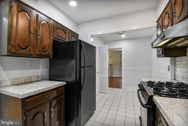 1627 Myrtle St NW, Washington, DC 20012 - kitchen with freestanding refrigerator, range with gas cooktop, extractor fan, and light countertops