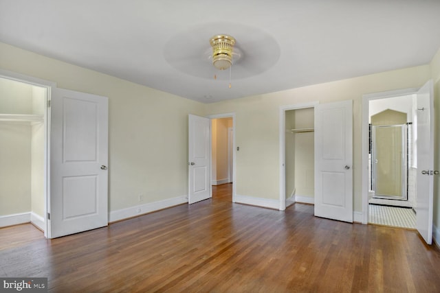 1627 Myrtle St NW, Washington, DC 20012 - unfurnished bedroom with a walk in closet, a closet, and wood finished floors