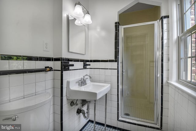 1627 Myrtle St NW, Washington, DC 20012 - full bathroom featuring tile walls, a stall shower, and wainscoting