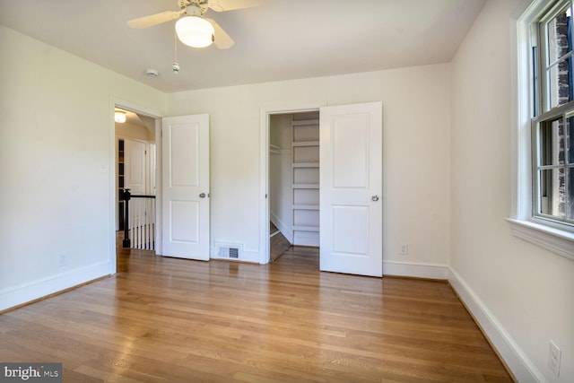 1627 Myrtle St NW, Washington, DC 20012 - unfurnished bedroom with light wood-style floors, a walk in closet, a closet, and ceiling fan