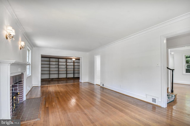 1627 Myrtle St NW, Washington, DC 20012 - unfurnished living room featuring wood-type flooring, a brick fireplace, and ornamental molding