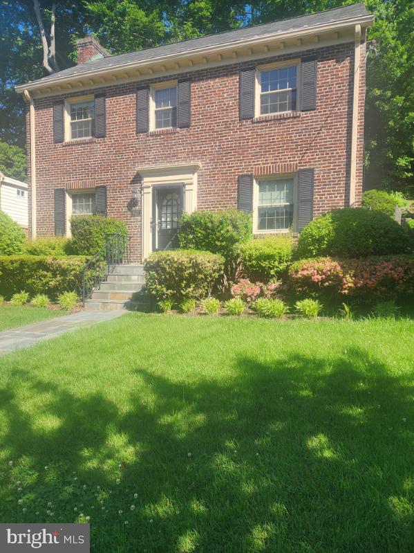 1627 Myrtle St NW, Washington, DC 20012 - view of front of house featuring a front lawn, brick siding, and a chimney