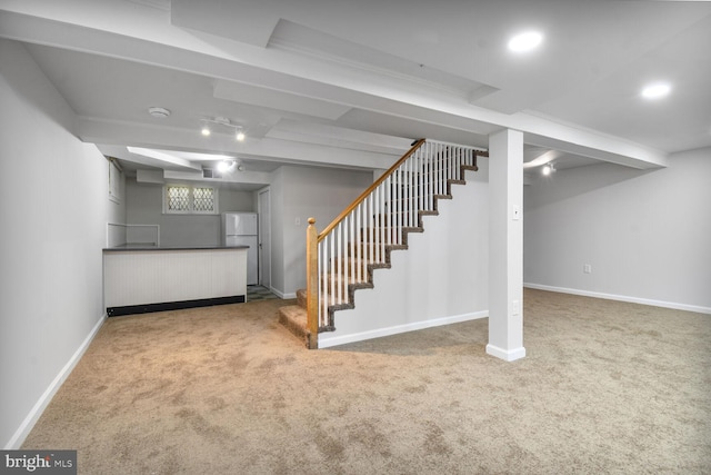 1627 Myrtle St NW, Washington, DC 20012 - basement with freestanding refrigerator, carpet flooring, stairs, and bar