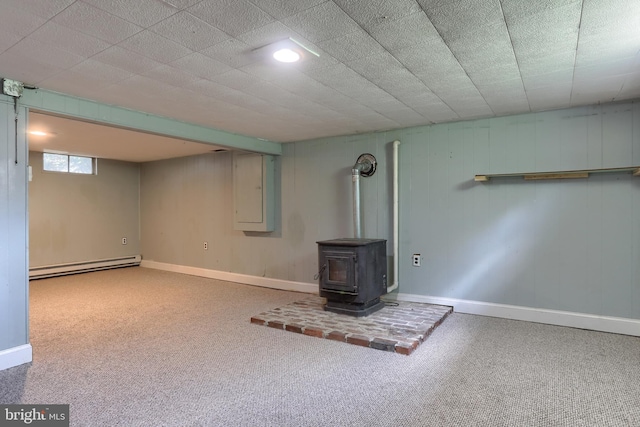 616 S 6th St, Lebanon, PA 17042 - basement featuring a baseboard radiator, a wood stove, carpet flooring, and electric panel