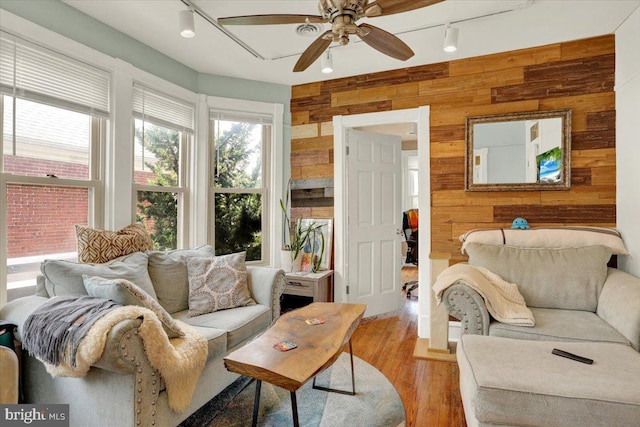 643 Penn, West Reading, PA 19611 - living room with wooden walls, track lighting, a ceiling fan, and light wood-style floors