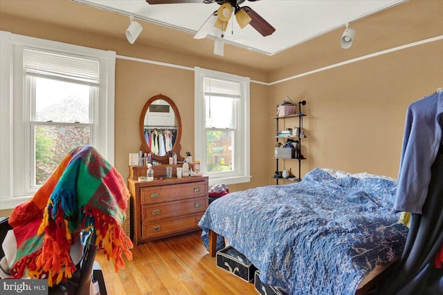 643 Penn, West Reading, PA 19611 - bedroom featuring rail lighting, wood finished floors, and a ceiling fan