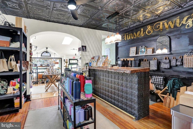 643 Penn, West Reading, PA 19611 - bar with arched walkways, wood finished floors, an ornate ceiling, and a ceiling fan