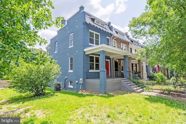 1233 Trinidad Ave NE, Washington, DC 20002 - view of front of home featuring a porch, brick siding, a front lawn, and mansard roof