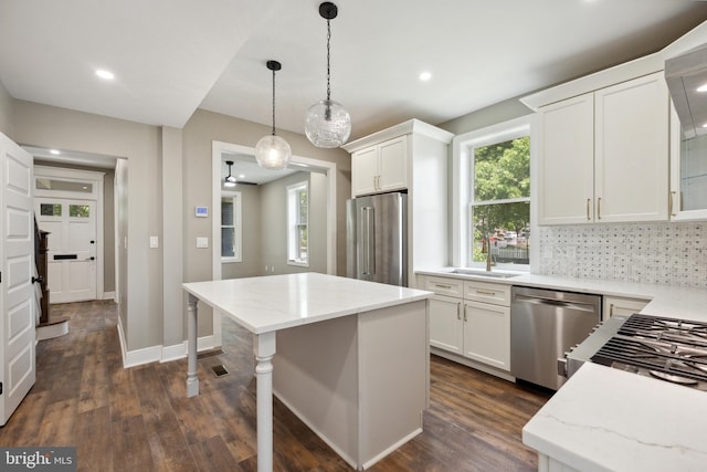 1233 Trinidad Ave NE, Washington, DC 20002 - kitchen featuring stainless steel appliances, dark wood-style flooring, white cabinetry, light stone countertops, and recessed lighting