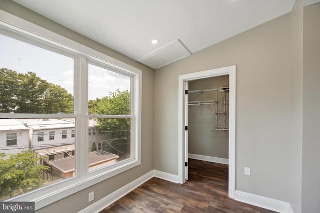 1233 Trinidad Ave NE, Washington, DC 20002 - unfurnished bedroom with multiple windows, attic access, dark wood-style flooring, a walk in closet, and recessed lighting