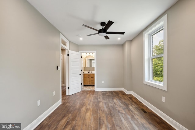 1233 Trinidad Ave NE, Washington, DC 20002 - unfurnished bedroom featuring dark wood-style flooring, recessed lighting, ensuite bathroom, a ceiling fan, and arched walkways