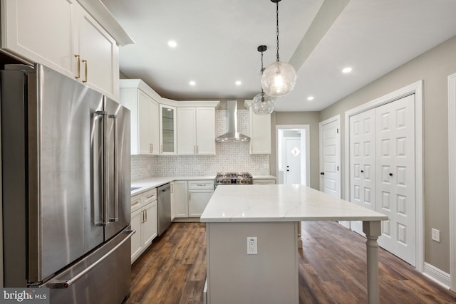 1233 Trinidad Ave NE, Washington, DC 20002 - kitchen with stainless steel appliances, wall chimney exhaust hood, backsplash, white cabinets, and dark wood-style flooring