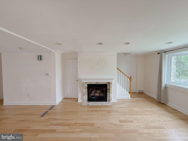 9235 Outlook Ave, Philadelphia, PA 19114 - unfurnished living room with light wood-type flooring, stairway, and a tile fireplace