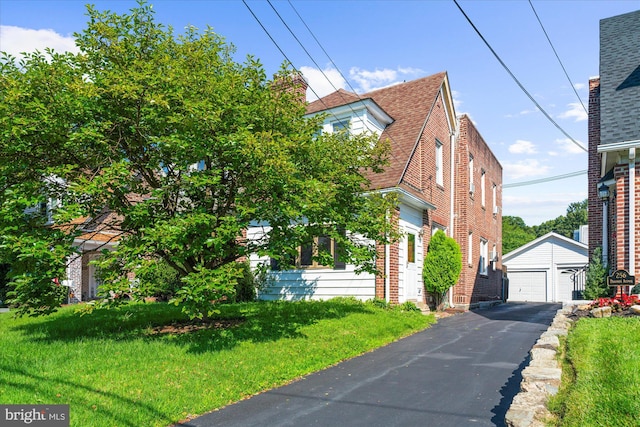 258 Pancoast Ave, Springfield, PA 19064 - view of front of house with an outdoor structure, a detached garage, a front lawn, and asphalt driveway