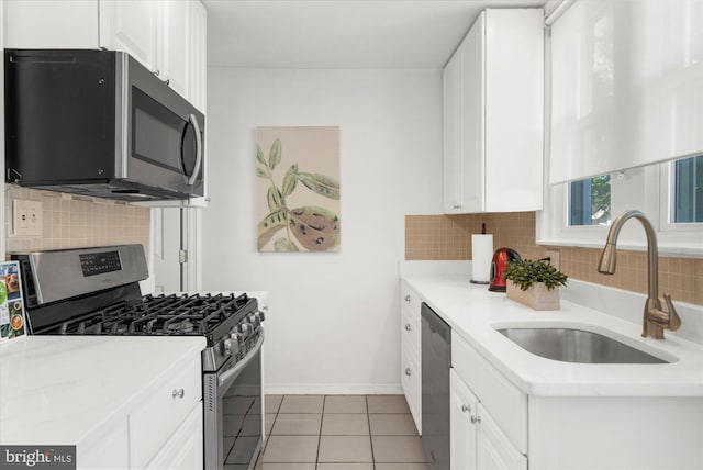 258 Pancoast Ave, Springfield, PA 19064 - kitchen featuring stainless steel appliances, backsplash, white cabinets, and light countertops