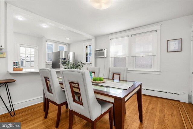 258 Pancoast Ave, Springfield, PA 19064 - dining area with baseboard heating, wood finished floors, and a wall mounted air conditioner