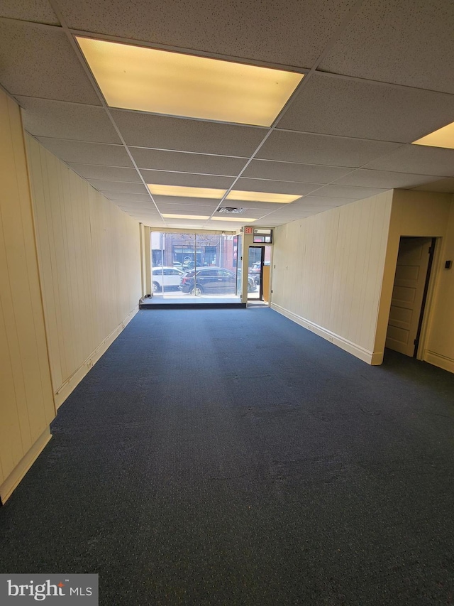 220 York Rd, Jenkintown, PA 19046 - spare room with a paneled ceiling, dark carpet, and wooden walls