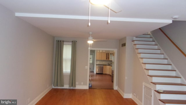 139 N 11th St, Allentown, PA 18102 - unfurnished living room with wood finished floors, stairway, and a ceiling fan