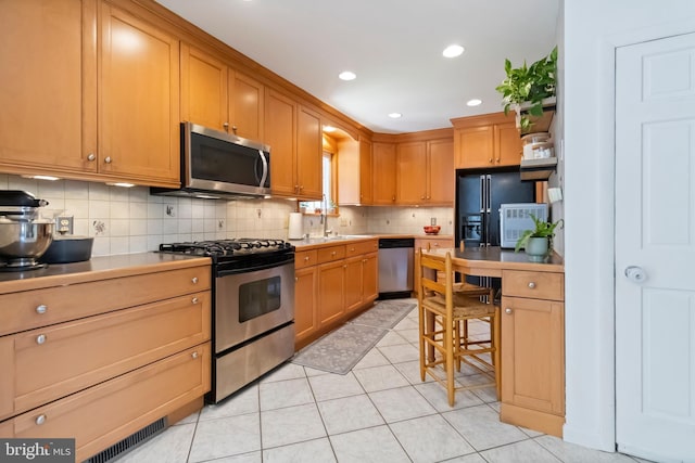 4715 Courtland St, Camp Hill, PA 17011 - kitchen with appliances with stainless steel finishes, decorative backsplash, light countertops, light tile patterned floors, and recessed lighting