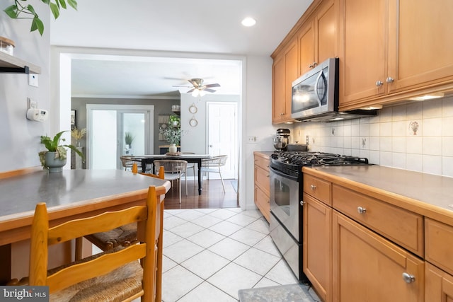 4715 Courtland St, Camp Hill, PA 17011 - kitchen featuring stainless steel appliances, backsplash, light tile patterned flooring, a ceiling fan, and crown molding