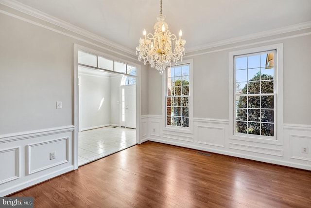 1050 Northfalls Ct, Great Falls, VA 22066 - unfurnished dining area featuring a chandelier, crown molding, wood finished floors, and a wainscoted wall