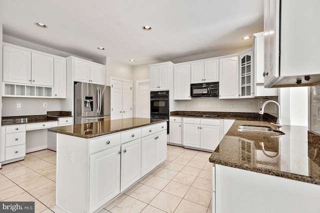 1050 Northfalls Ct, Great Falls, VA 22066 - kitchen with black appliances, a center island, dark stone counters, white cabinetry, and recessed lighting