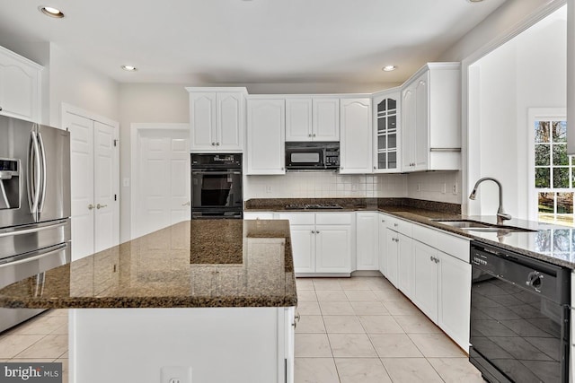 1050 Northfalls Ct, Great Falls, VA 22066 - kitchen with black appliances, dark stone counters, tasteful backsplash, glass insert cabinets, and recessed lighting
