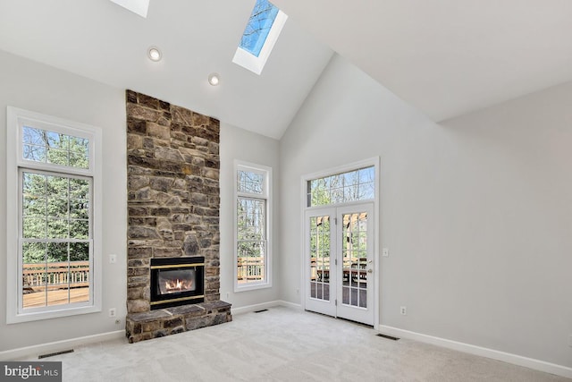 1050 Northfalls Ct, Great Falls, VA 22066 - unfurnished living room with high vaulted ceiling, a skylight, healthy amount of natural light, carpet, and a stone fireplace