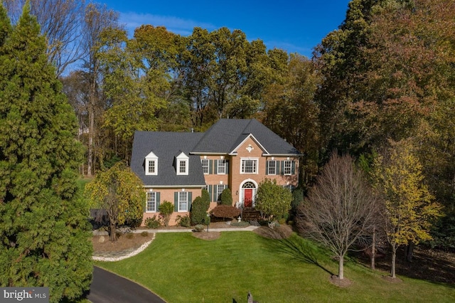 1050 Northfalls Ct, Great Falls, VA 22066 - georgian-style home with a front yard and brick siding