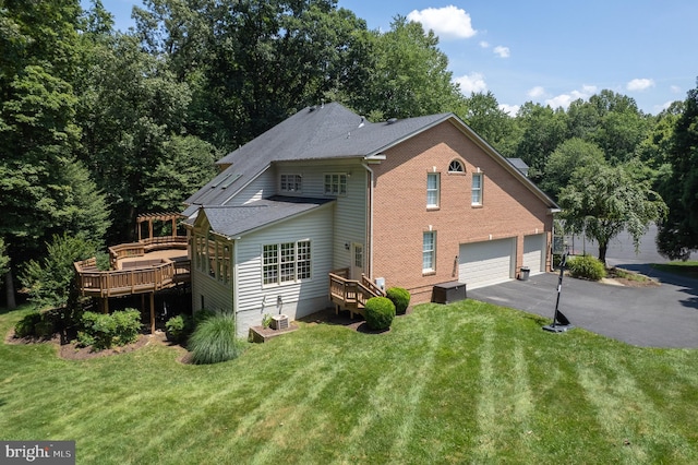 1050 Northfalls Ct, Great Falls, VA 22066 - back of house with asphalt driveway, a garage, a lawn, and a deck