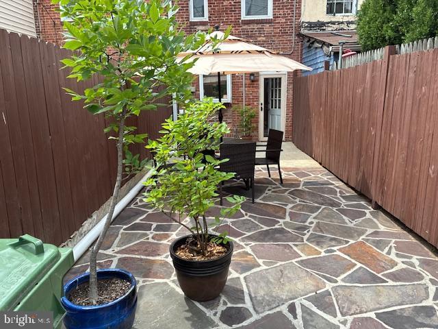 1457 Woodall St, Baltimore, MD 21230 - fenced backyard with a patio