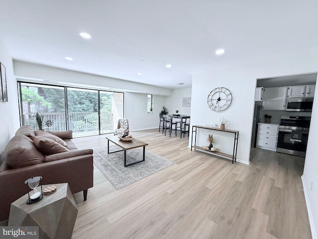 12 Monroe St Unit 12-302, Rockville, MD 20850 - living room featuring healthy amount of natural light, light wood-type flooring, and recessed lighting