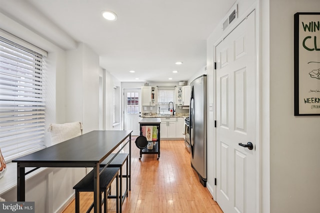 330 W George St, Philadelphia, PA 19123 - kitchen with freestanding refrigerator, white cabinetry, recessed lighting, light wood-style flooring, and light stone countertops