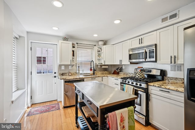 330 W George St, Philadelphia, PA 19123 - kitchen with appliances with stainless steel finishes, open shelves, plenty of natural light, white cabinetry, and recessed lighting