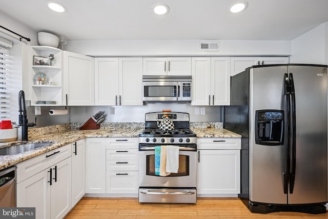 330 W George St, Philadelphia, PA 19123 - kitchen with appliances with stainless steel finishes, open shelves, white cabinets, light wood-type flooring, and recessed lighting