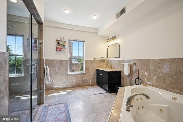 330 W George St, Philadelphia, PA 19123 - full bath with tile walls, vanity, a whirlpool tub, a wainscoted wall, and a stall shower