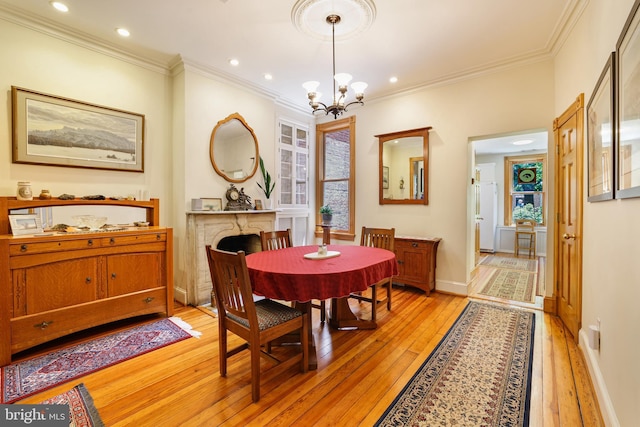 637 Constitution Ave NE, Washington, DC 20002 - dining area with light wood finished floors, a chandelier, crown molding, a high end fireplace, and recessed lighting