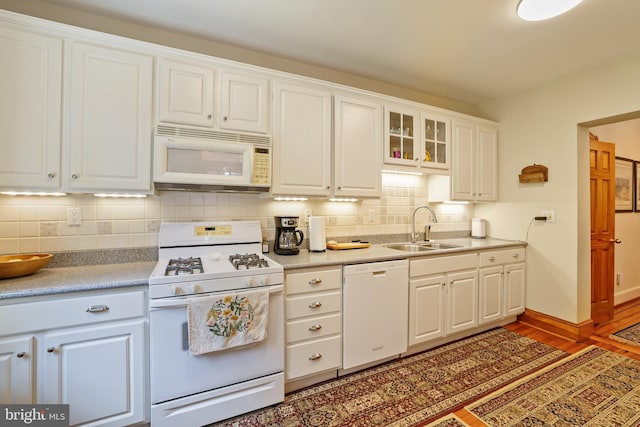637 Constitution Ave NE, Washington, DC 20002 - kitchen with white appliances, tasteful backsplash, light wood-style floors, white cabinets, and glass insert cabinets