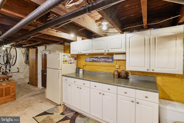 637 Constitution Ave NE, Washington, DC 20002 - kitchen with freestanding refrigerator, electric panel, dark countertops, and white cabinets