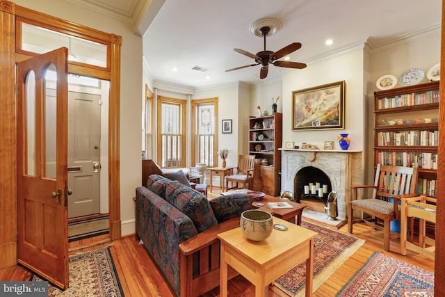 637 Constitution Ave NE, Washington, DC 20002 - living area featuring light wood-style floors, a ceiling fan, crown molding, recessed lighting, and a fireplace with raised hearth