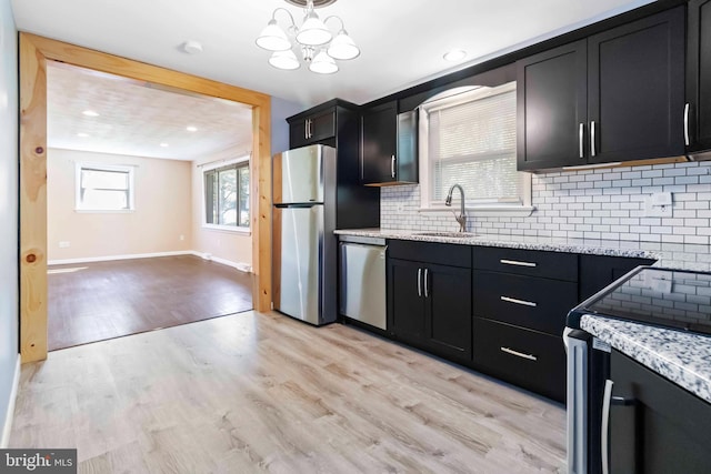 663 Newberry Rd, Middletown, PA 17057 - kitchen featuring stainless steel appliances, dark cabinetry, tasteful backsplash, light wood-type flooring, and recessed lighting