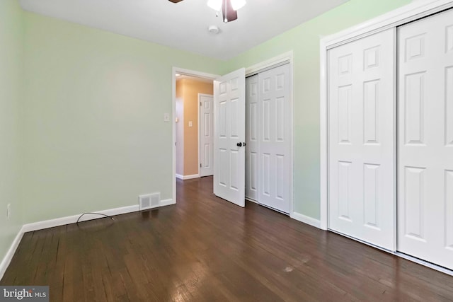663 Newberry Rd, Middletown, PA 17057 - unfurnished bedroom with dark wood finished floors, two closets, and a ceiling fan