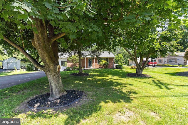 663 Newberry Rd, Middletown, PA 17057 - view of property hidden behind natural elements with a front yard and brick siding