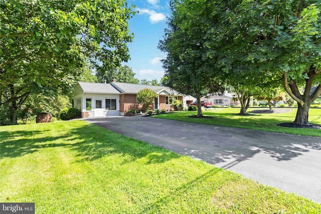 663 Newberry Rd, Middletown, PA 17057 - view of front of house featuring asphalt driveway, brick siding, and a front yard